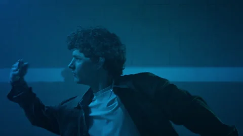 Young Man Dancing Hip Hop in Monochromatic Blue Light Stock Footage 335680872