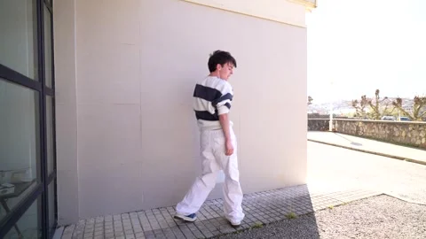 Young man dancing modern choreography outdoors Stock Footage 303335414
