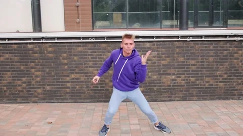 Young man dancing modern dance, hip hop on the city street Stock Footage 139758484