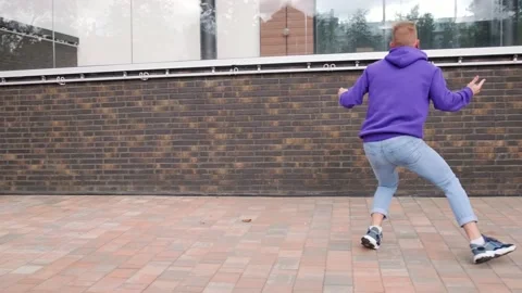 Young man dancing modern dance, hip hop on the city street Stock Footage 139758542