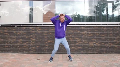 Young man dancing modern dance, hip hop on the city street Stock Footage 139758557