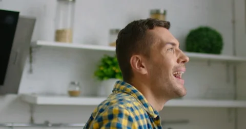 Young man is dancing in a modern kitchen Stock Footage 113226890