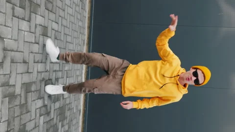 Young Man dancing moving his hands with his legs with making funny faces Stock Footage 165603522