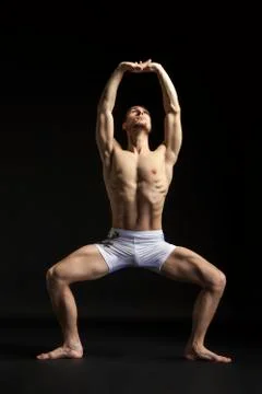Young man dancing over black Stock Photos
