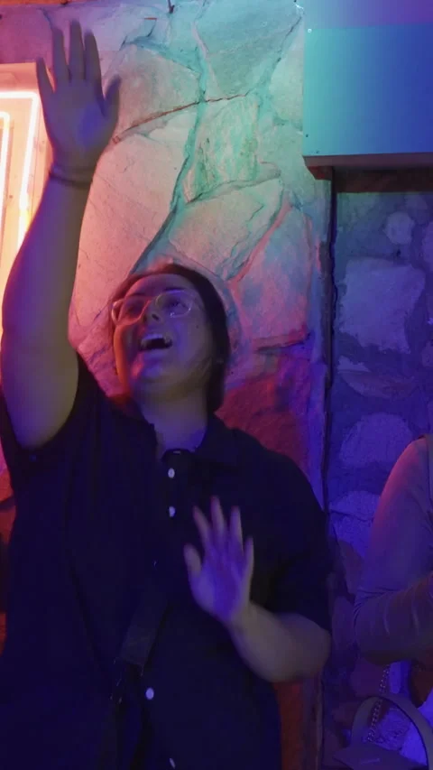 Young Man Dancing with Raised Hand at Nightclub Party Stock Footage 337887346