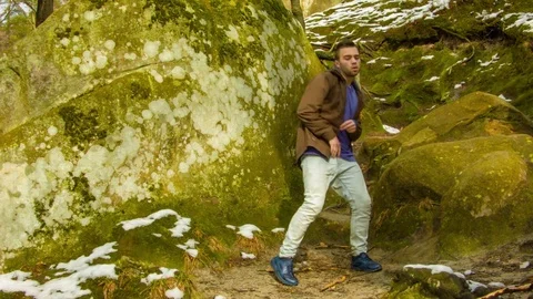 Young man dancing on a rock Видео 81231700