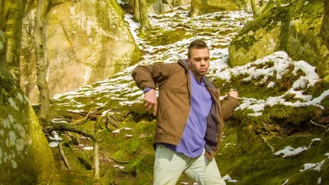 Young man dancing on a rock Stock Footage 81231701
