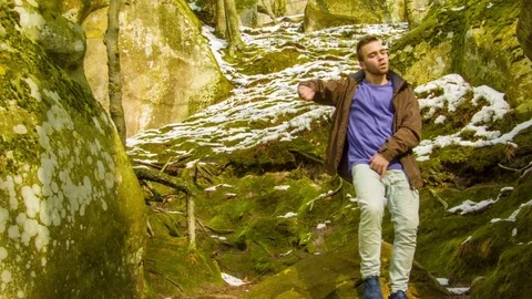 Young man dancing on a rock Stock Footage 81231739