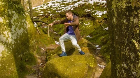Young man dancing on a rock 스톡 동영상 81231754