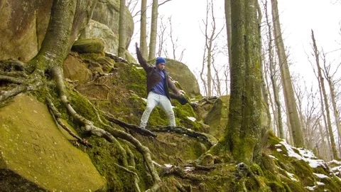 Young man dancing on a rock Video stock 82530960