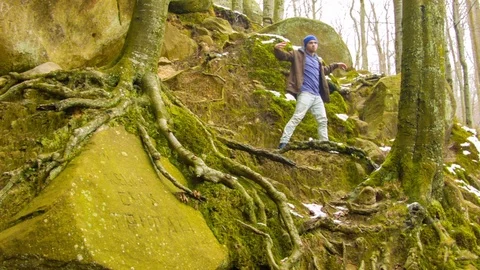 Young man dancing on a rock Video stock 82531863