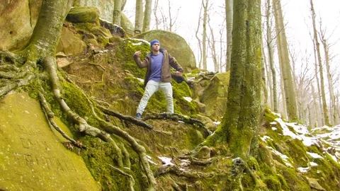 Young man dancing on a rock 스톡 동영상 82537396