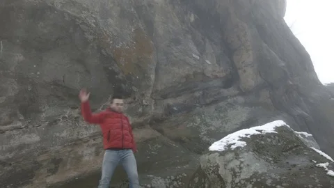 Young man dancing on a rock Video stock 82586715