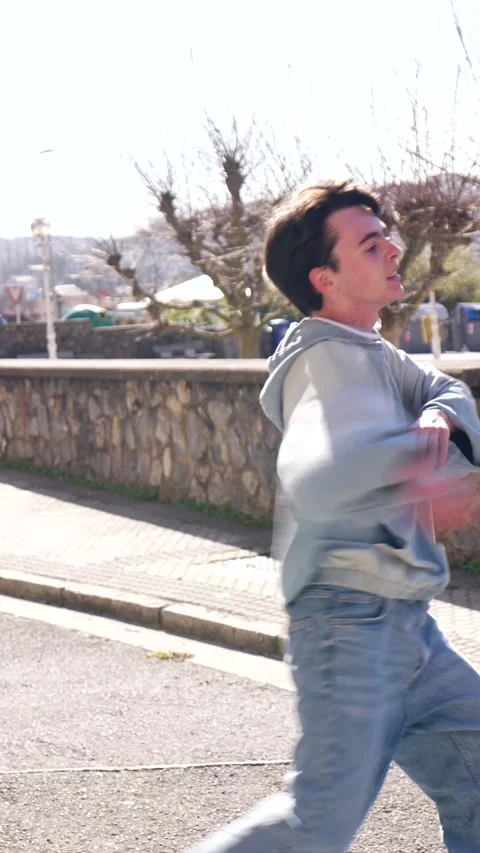 Young man dancing in the street Stock Footage 303335465