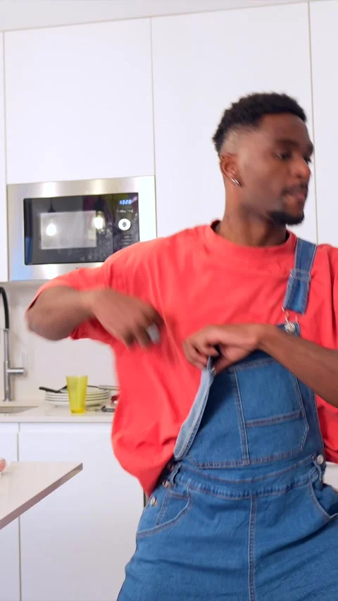 Young man dancing urban style in kitchen Stock Footage 303152984