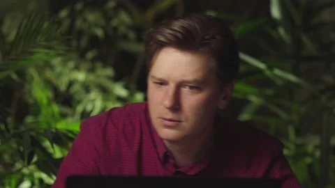 Young man dancing while sitting at the computer Stock Footage 149036209