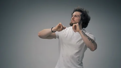 Young man dancing on white Stock Footage 126723884