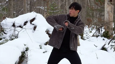 Young Man Dancing in Winter Forest - Slowmo Stock Footage 100874485