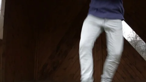 Young man dancing on a wooden bus stop Vídeo Stock 82589837