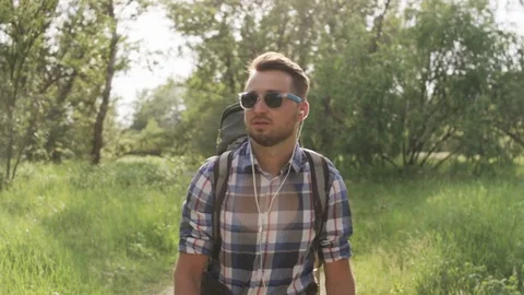 Young Man With Dark Glasses Walking in the Woods Stock Footage 77671492