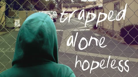 Young man dealing with depression facing fence Stock Footage 38680660