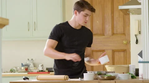 Young man decides to make home made Pizza for Dinner. Video stock 63006142