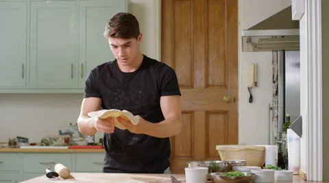 Young man decides to make home made Pizza for Dinner. Stock Footage 63020738
