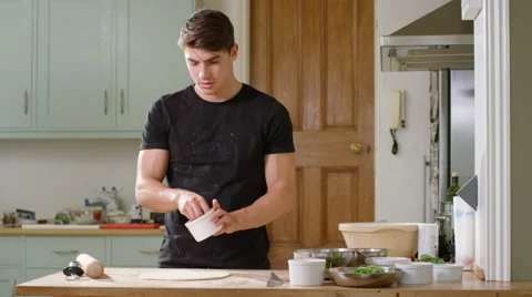 Young man decides to make home made Pizza for Dinner. Stock Footage 63025722