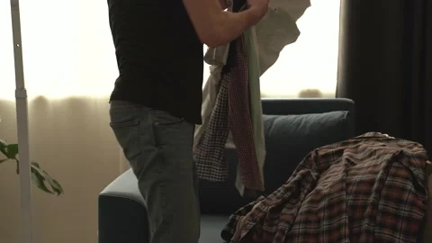 Young man declutters his wardrobe. Stock Footage 196586878