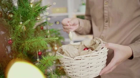 A young man decorates a Christmas tree vintage balls. Merry Christmas and Happy Stock Footage 161459966