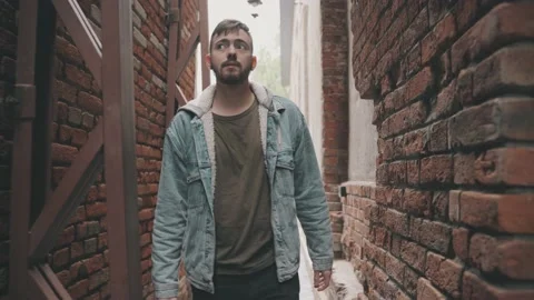 Young man in denim jacket walks through the vintage tunnel Vidéo 144851509