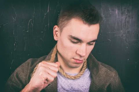 A young man in the depression pulls the rope. Stock Photos