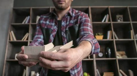 Young man designer manually assemble small packaging cardboard box for products Stock Photos
