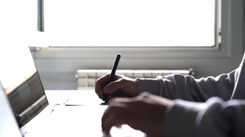 Young man designer using a stylus, graphics table and computer. Person telewo Stock Footage 133233727