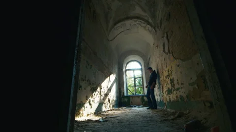Young man in despair goes to an abandoned house. Concept: job loss, depression Stock Footage 54234337