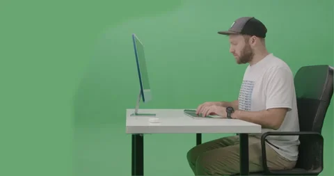 Young Man Developer Using Computer To Write Code on his desktop computer Stock Footage 259859901