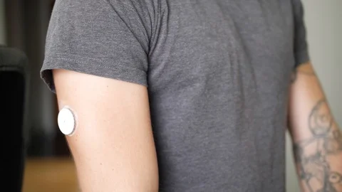 A young man with diabetes checks his blood glucose levels in his home with Stock Footage 93665853