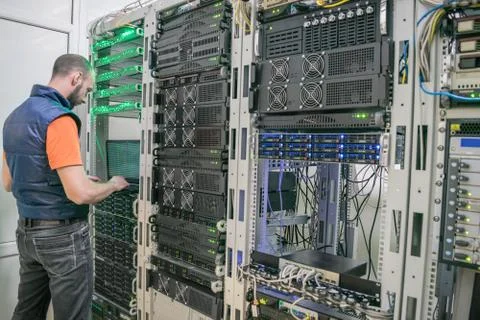 Young man diagnoses problems in the work of the information center. System ad Stock Photos