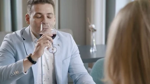 Young man dining in the restaurant: wine and a salad on the table. Video stock 77234652