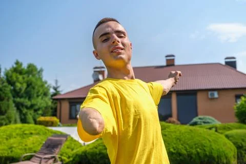 Young man with disability exercising in yard Stock Photos