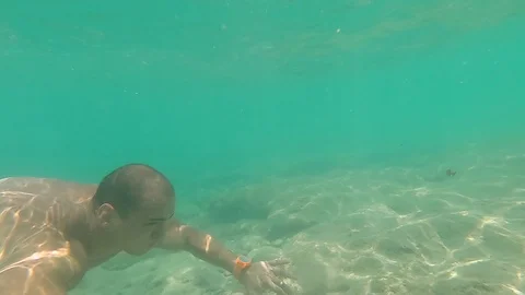 Young man dives free underwater GoPro Hero7 Stock Footage 109105853