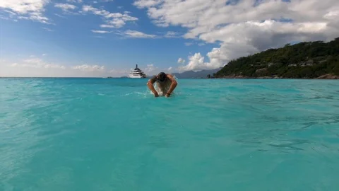A young man dives in the Indian Ocean. Stock Footage 101973989