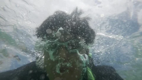 Young Man Diving Underwater with Action Camera Selfie During Summer Vacation Stock Footage 338185962