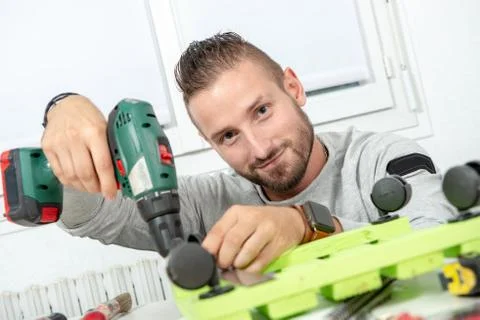 Young man DIY using electric drill Stock Photos