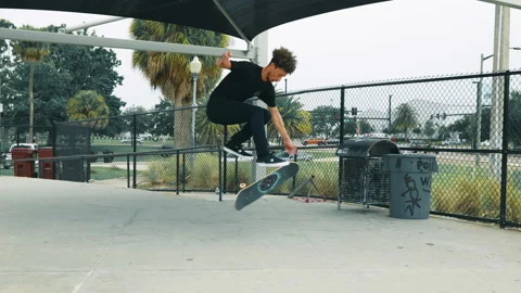 Young Man Does 2 Flip Tricks At Skatepark Angle 2 Stock Footage 161932501