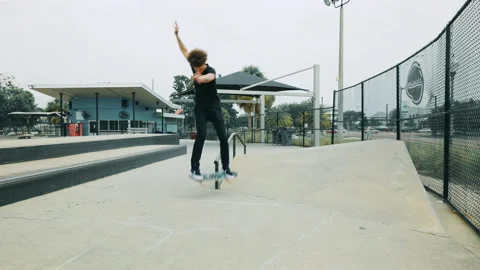 A Young Man Does A Flip Trick Into Rail Grind Stock Footage 167987105