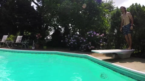 Young man does front flip dive off of diving board. Stock Footage 54304748