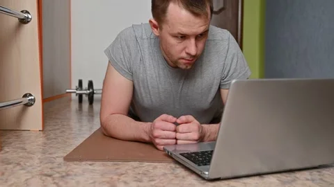Young man does plank exercise at home. New normal. Stock Footage 132793535
