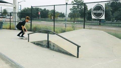 Young Man Does Trick Into A Grind At A Skatepark Video stock 167986375