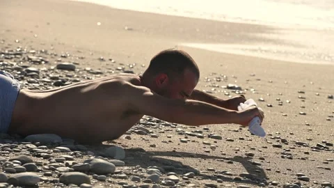 Young man doing abc exercise on the beach 스톡 동영상 257478804